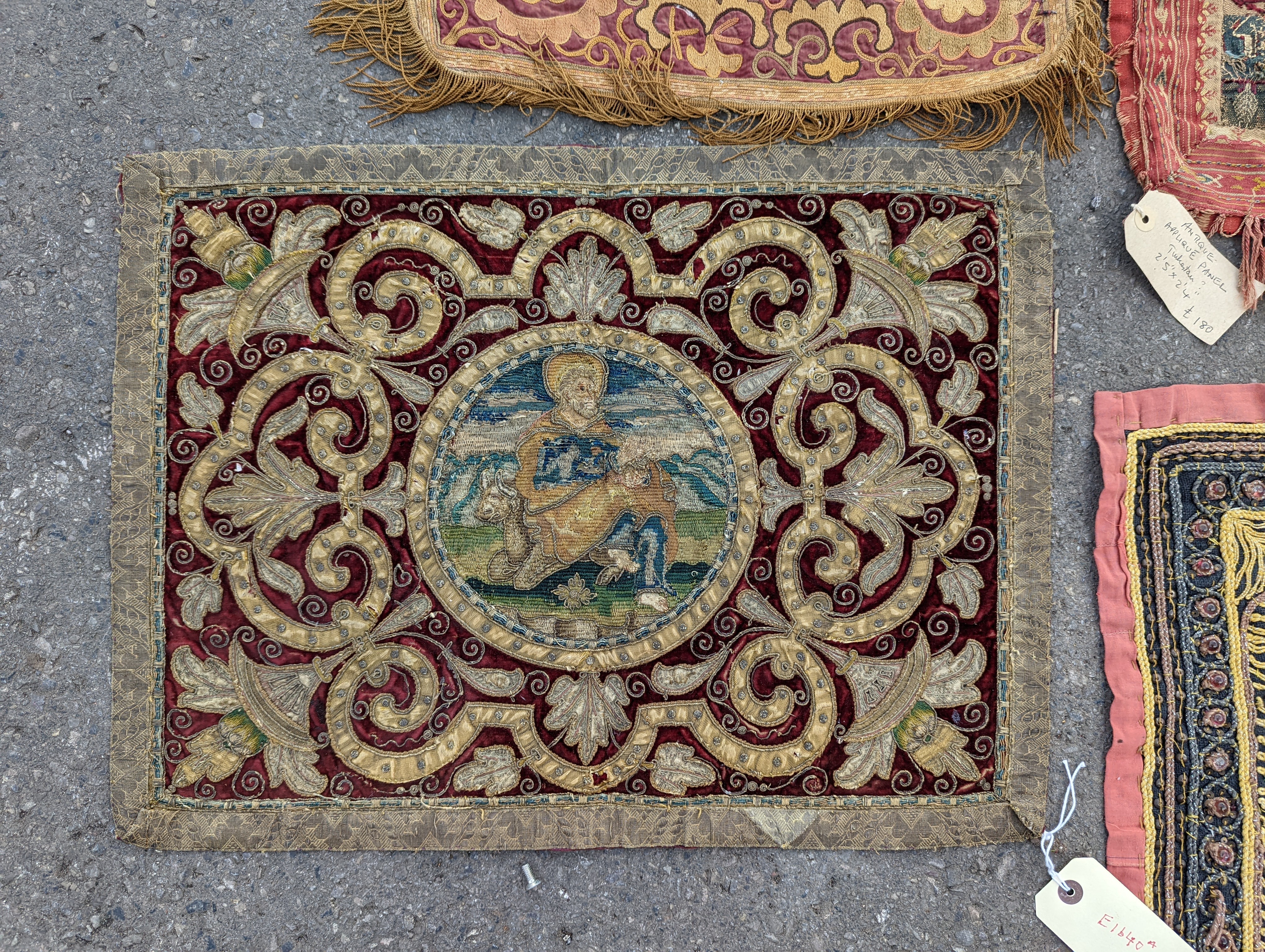 An Indian appliqué panel, two Indian appliqué covers and one other.